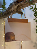 Postkarte "Kerze am Meer" | Eine weihnachtlich leuchtende Illustration.